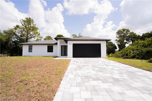 1603 E 5th St, Lehigh Acres, FL 33972 - view of front of home with an attached garage, decorative driveway, stucco siding, and a front yard
