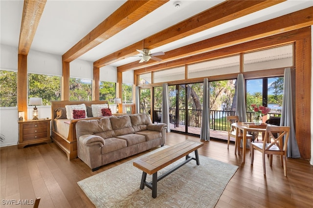 interior space featuring a wealth of natural light, a wooden deck, wood-type flooring, and beamed ceiling