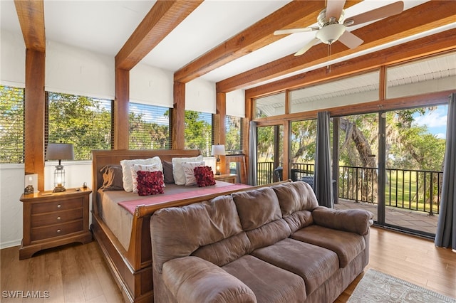 bedroom featuring access to outside, beam ceiling, and wood finished floors