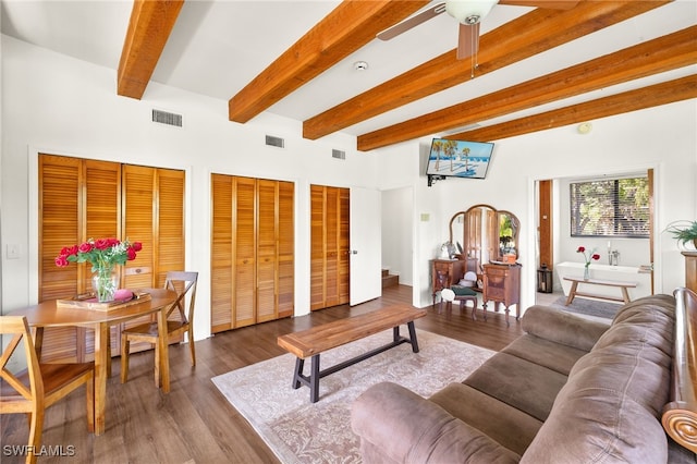 living room featuring beam ceiling, visible vents, and wood finished floors