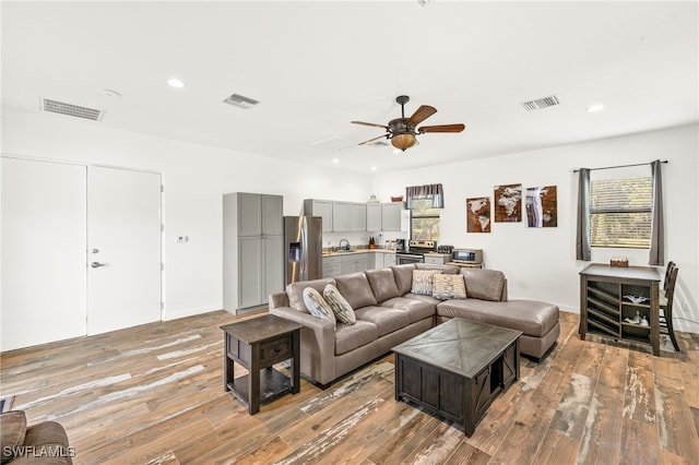 living area featuring a wealth of natural light, recessed lighting, and visible vents