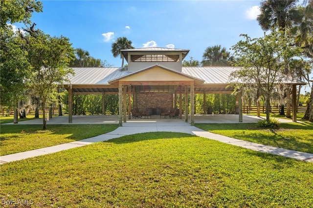 view of home's community with fence and a lawn