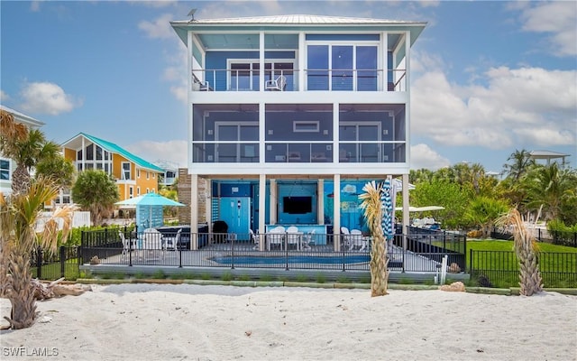 4620 Oro Pesos Ln, Upper Captiva, FL 33924 - view of front facade featuring a sunroom, a balcony, and a patio area
