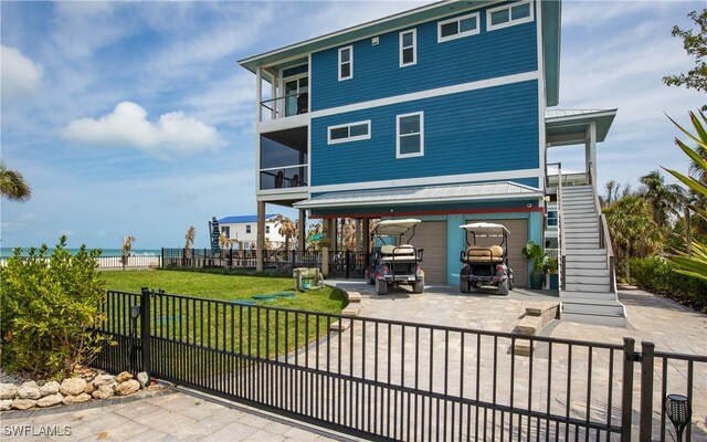 4620 Oro Pesos Ln, Upper Captiva, FL 33924 - rear view of house with stairs, metal roof, and a balcony