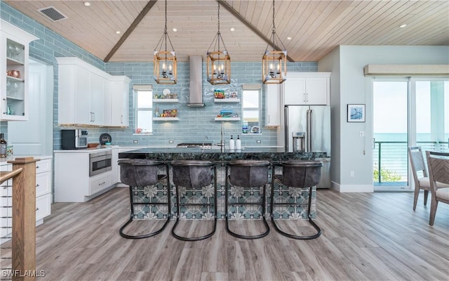 4620 Oro Pesos Ln, Upper Captiva, FL 33924 - kitchen with wooden ceiling, appliances with stainless steel finishes, light wood-type flooring, open shelves, and white cabinets