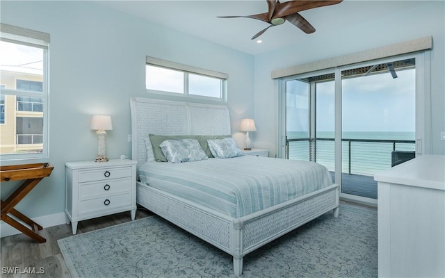 4620 Oro Pesos Ln, Upper Captiva, FL 33924 - bedroom with access to exterior, dark wood finished floors, baseboards, a water view, and ceiling fan