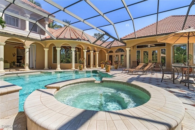 view of pool with a patio, a pool with connected hot tub, french doors, and a ceiling fan