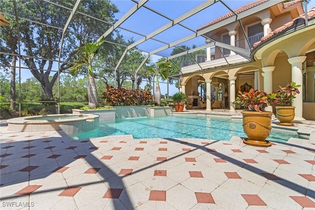 view of swimming pool with a patio area, a pool with connected hot tub, and glass enclosure