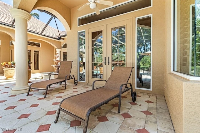 view of patio / terrace featuring french doors, a lanai, and ceiling fan