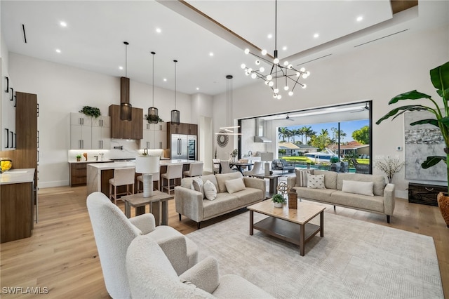127 SW 56th Ter, Cape Coral, FL 33914 - living room featuring baseboards, light wood-style flooring, a high ceiling, and recessed lighting