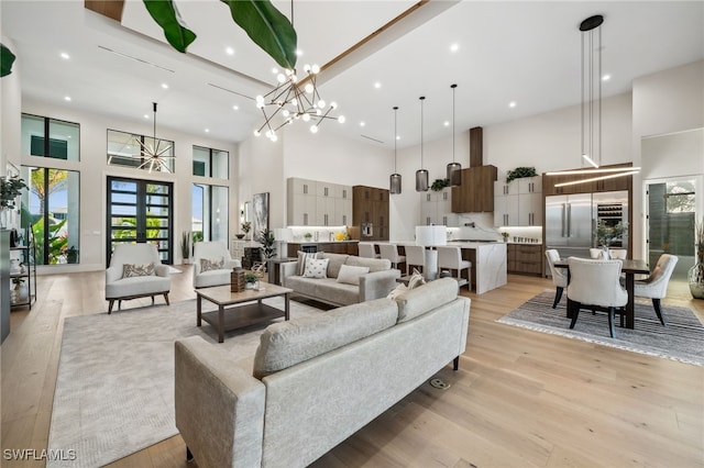127 SW 56th Ter, Cape Coral, FL 33914 - living area featuring recessed lighting, a chandelier, a towering ceiling, and light wood-style floors