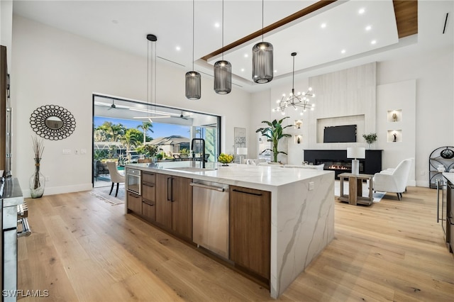 127 SW 56th Ter, Cape Coral, FL 33914 - kitchen with modern cabinets, stainless steel dishwasher, a spacious island, and light wood-style flooring