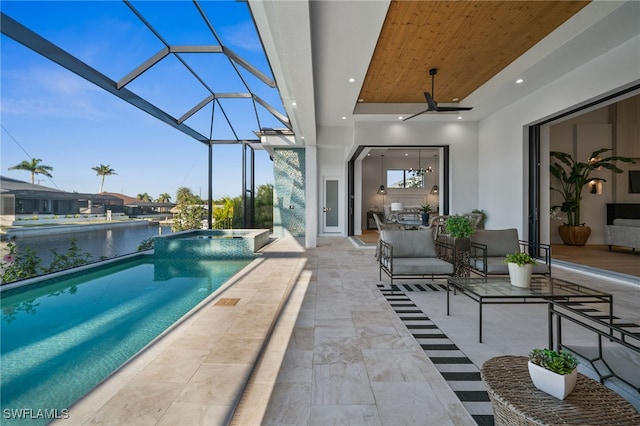 127 SW 56th Ter, Cape Coral, FL 33914 - view of swimming pool featuring glass enclosure, a water view, ceiling fan, a patio, and a pool with connected hot tub