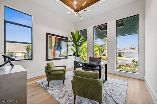 127 SW 56th Ter, Cape Coral, FL 33914 - living area with light wood-style floors, plenty of natural light, baseboards, and a notable chandelier