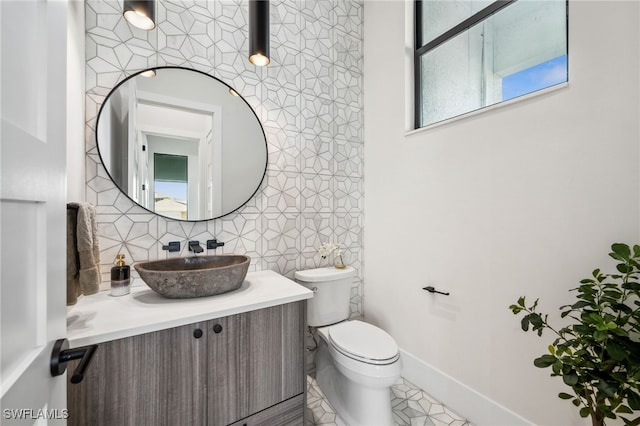 127 SW 56th Ter, Cape Coral, FL 33914 - half bathroom with tile patterned floors, decorative backsplash, vanity, baseboards, and toilet