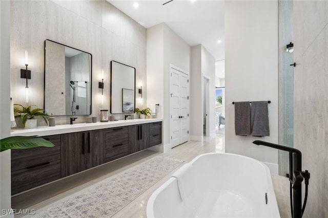 127 SW 56th Ter, Cape Coral, FL 33914 - bathroom with baseboards, a freestanding tub, wood finished floors, and double vanity