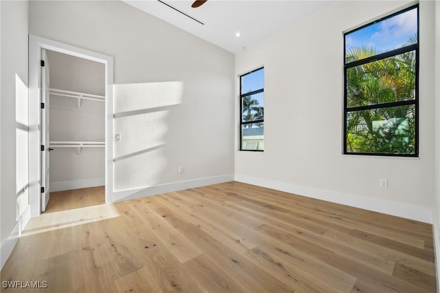 127 SW 56th Ter, Cape Coral, FL 33914 - unfurnished bedroom featuring wood finished floors, lofted ceiling, and baseboards