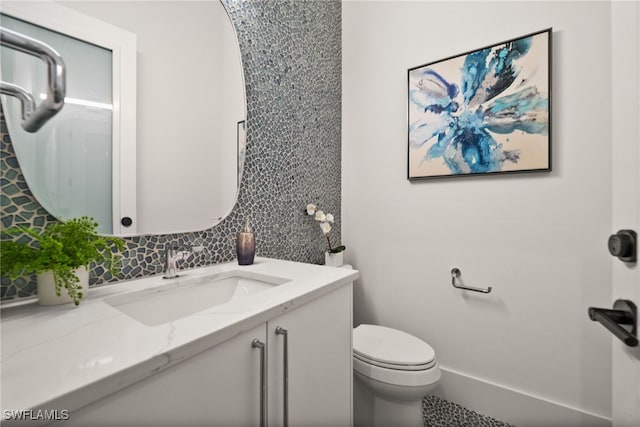 127 SW 56th Ter, Cape Coral, FL 33914 - bathroom with decorative backsplash, vanity, and toilet
