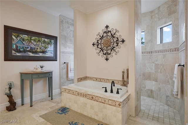 bathroom with a bath, baseboards, ornamental molding, and a walk in shower