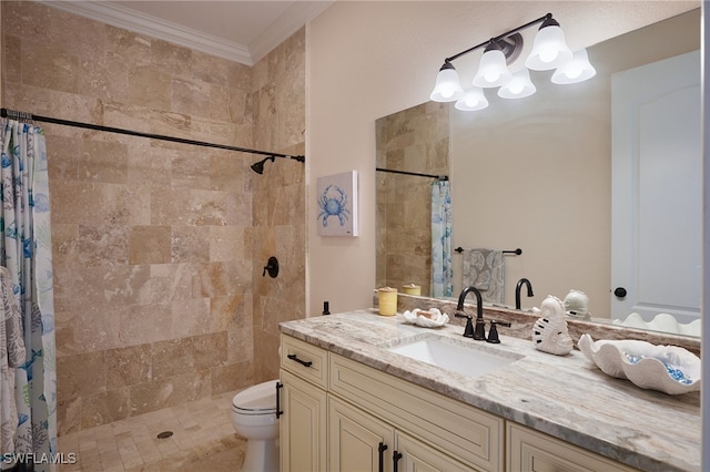 bathroom with toilet, tiled shower, vanity, and crown molding