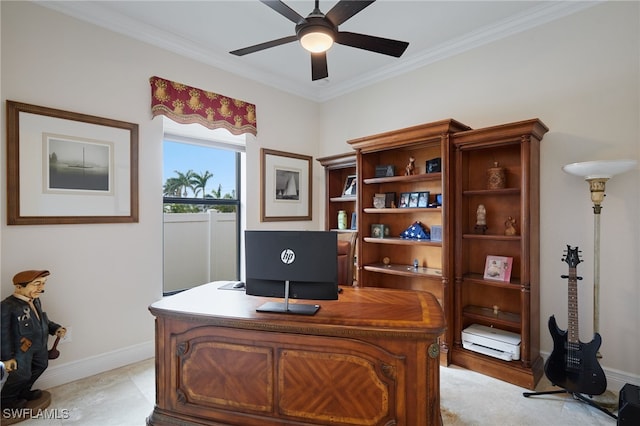office space with ornamental molding, baseboards, and a ceiling fan