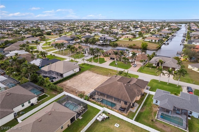 drone / aerial view featuring a water view and a residential view