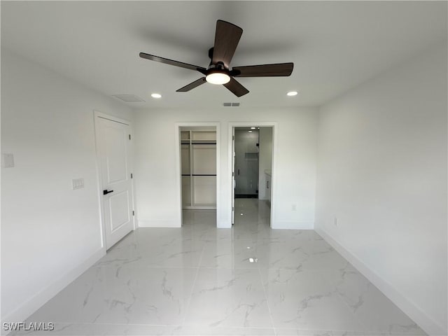 1701 W 11th St, Lehigh Acres, FL 33972 - unfurnished bedroom featuring baseboards, light marble finish flooring, recessed lighting, a spacious closet, and ceiling fan