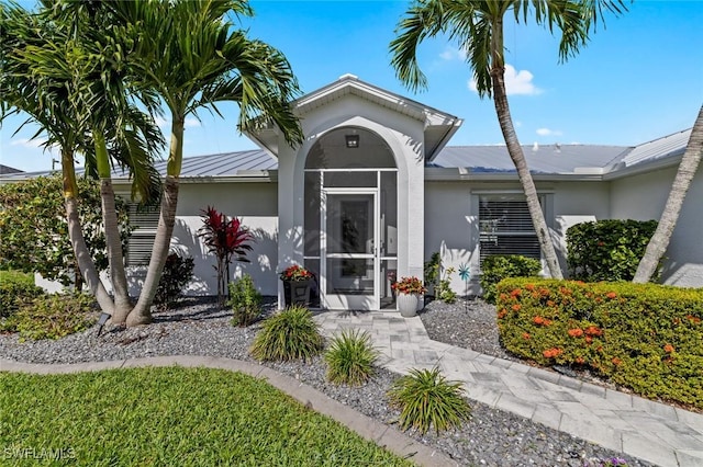 4002 SW 26th Ct, Cape Coral, FL 33914 - entrance to property featuring a standing seam roof, metal roof, and stucco siding