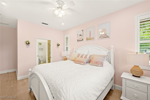 5794 Elizabeth Ann Way, Fort Myers, FL 33912 - bedroom featuring visible vents, light wood-style flooring, ensuite bathroom, and baseboards