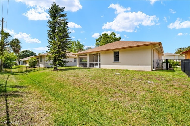 5794 Elizabeth Ann Way, Fort Myers, FL 33912 - back of house featuring a sunroom, central air condition unit, a yard, a fenced backyard, and stucco siding