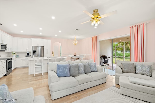 5794 Elizabeth Ann Way, Fort Myers, FL 33912 - living room with arched walkways, light wood finished floors, a ceiling fan, and recessed lighting