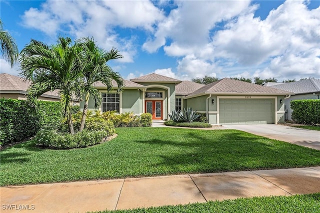 mediterranean / spanish-style house with an attached garage, concrete driveway, stucco siding, and a front yard
