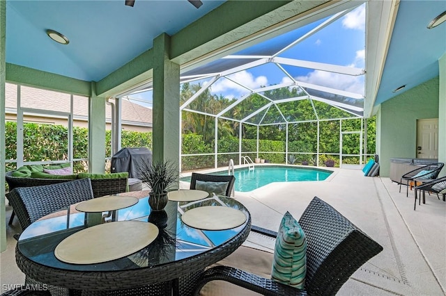 pool featuring grilling area, outdoor dining area, a patio area, and a lanai