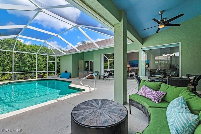 pool featuring a patio area, outdoor lounge area, ceiling fan, and glass enclosure