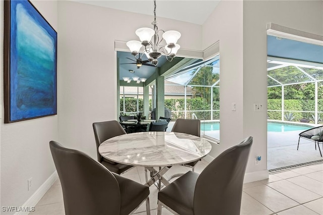 dining area with a chandelier, a wealth of natural light, a sunroom, and light tile patterned flooring