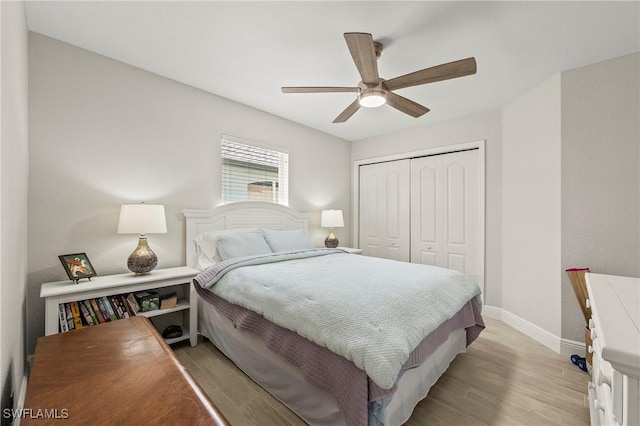 bedroom featuring light wood finished floors, a closet, baseboards, and a ceiling fan