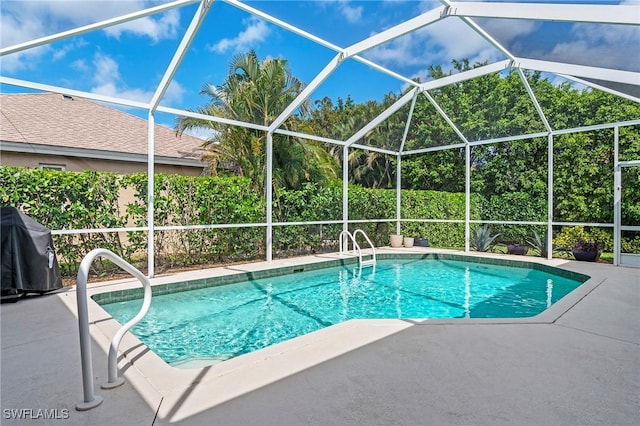 pool featuring a patio and glass enclosure