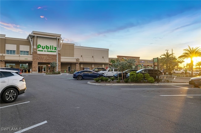 property at dusk featuring uncovered parking