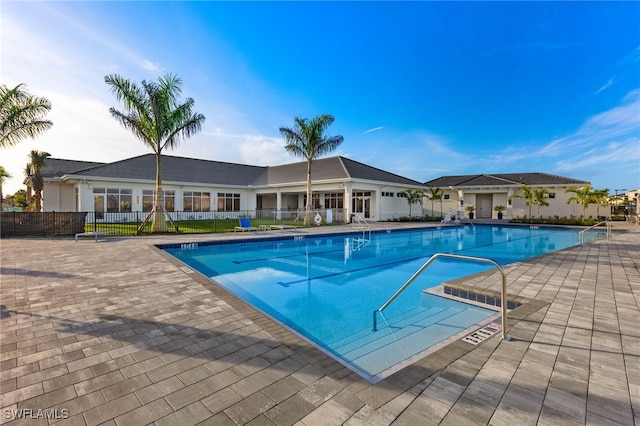 pool with fence and a patio area