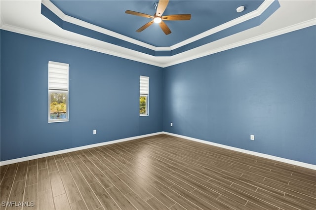 empty room featuring ceiling fan, baseboards, and a raised ceiling
