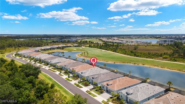 aerial view with golf course view, a water view, and a residential view