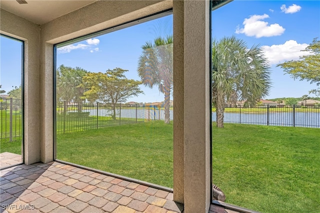 unfurnished sunroom featuring a water view