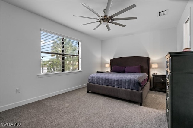 bedroom with visible vents, baseboards, a ceiling fan, and light carpet
