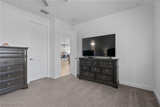 bedroom with carpet flooring, visible vents, baseboards, and a ceiling fan
