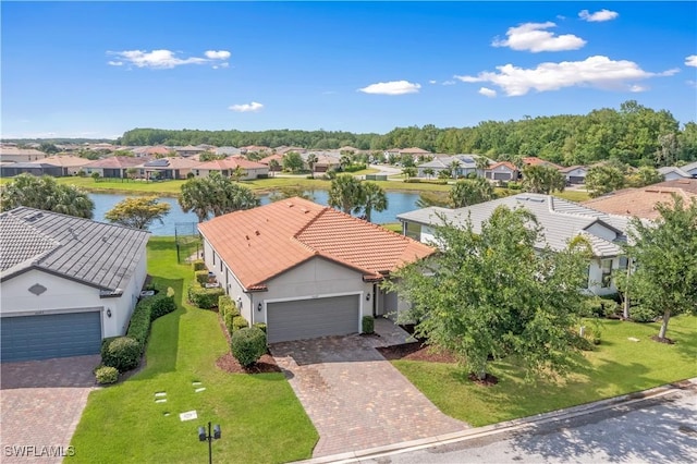 birds eye view of property with a water view and a residential view