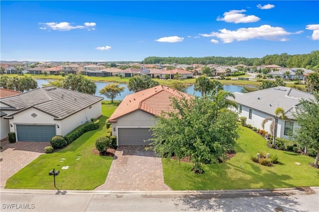 drone / aerial view with a water view and a residential view