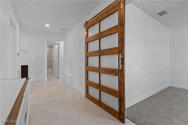 hall with recessed lighting, light tile patterned floors, visible vents, and baseboards