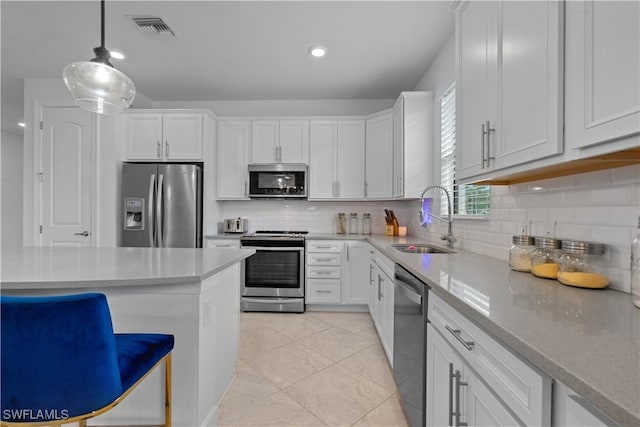 kitchen featuring a sink, visible vents, white cabinetry, and stainless steel appliances
