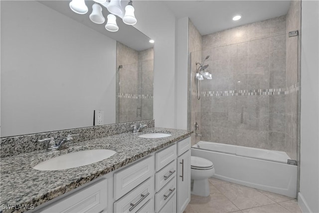 full bath with a sink, toilet, double vanity, and tile patterned flooring