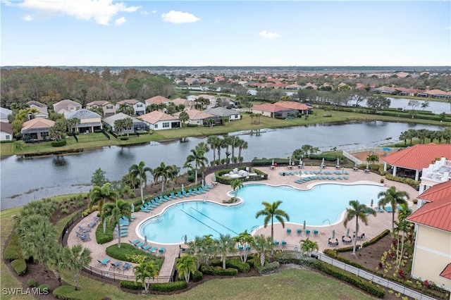 drone / aerial view with a water view and a residential view